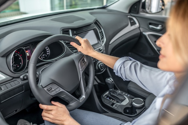 Confident woman driving in car during day