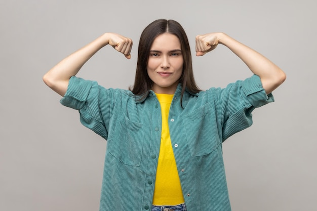 Confident woman showing biceps expressing power ambitions to become successful feminism concept