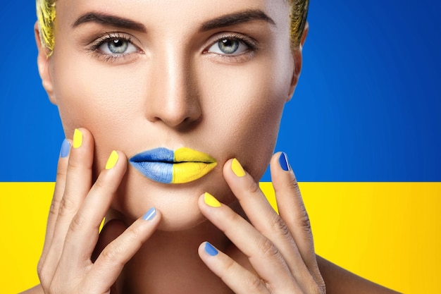 Confident woman with yellow blue lipstick and Ukrainian flag on background