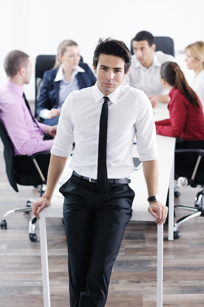 Confident young business man attending a meeting with his colleagues