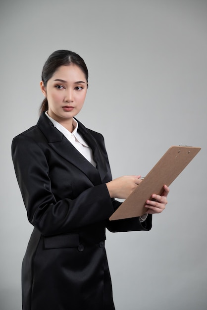 Confident young businesswoman stands on isolated background Enthusiastic