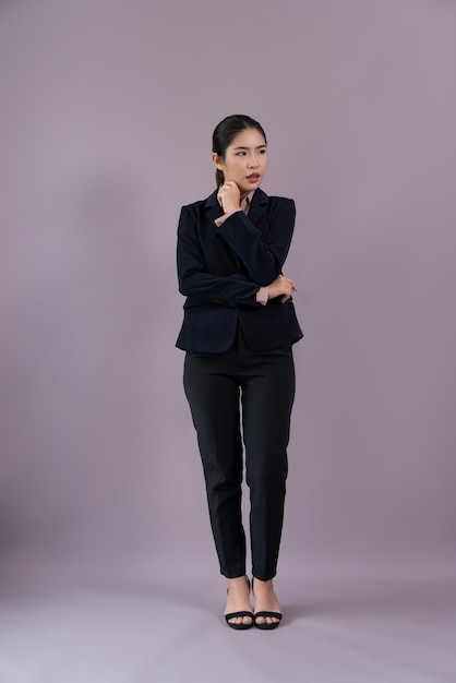 Confident young businesswoman stands on isolated background Enthusiastic