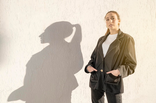 Confident young caucasian mediterranean woman standing in the city with shadow