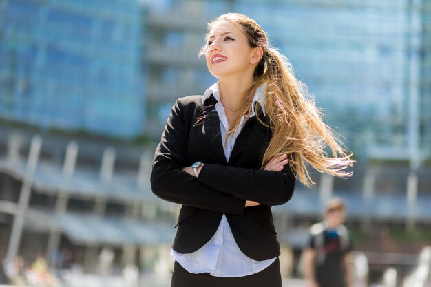 Confident young female manager outdoor in a modern urban setting