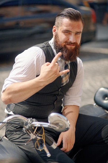 Confident young man  sitting on a motorbike