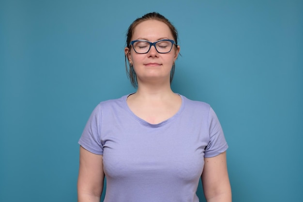 Confident young woman with closed eyes in studio