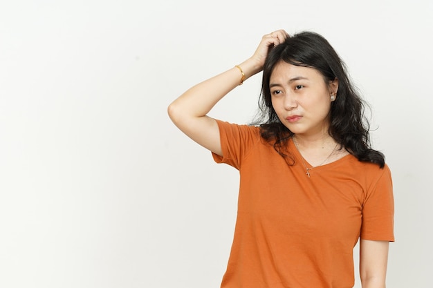 Confused face expression of beautiful asian woman Wearing orange Tshirt isolated on white