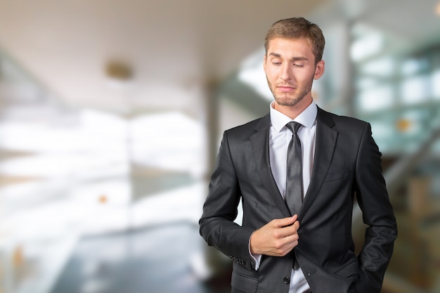 Confused young businessman thinking