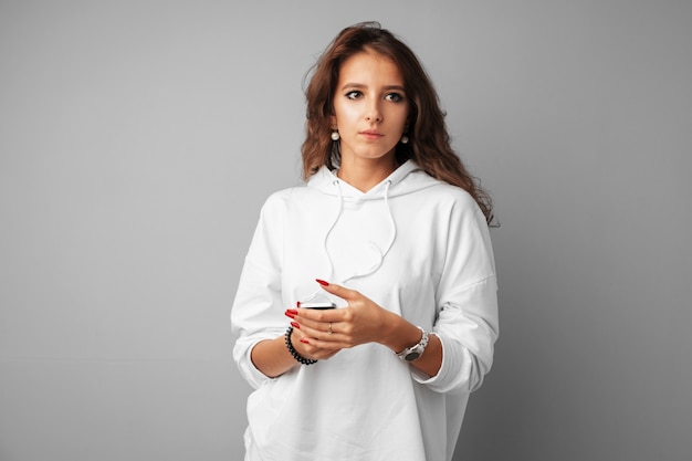 Confused young woman looking aside over gray background