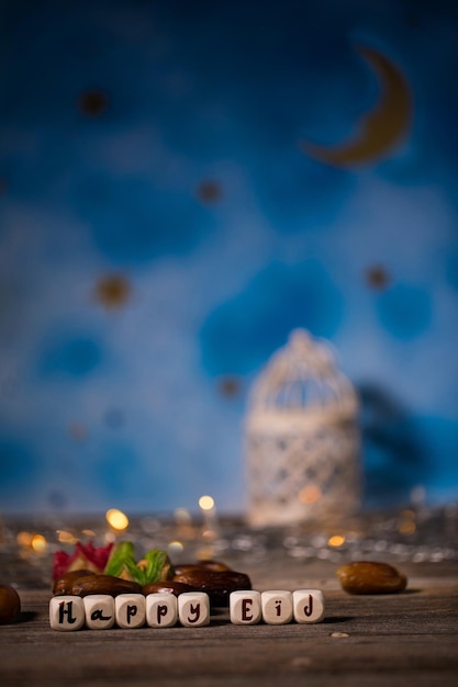 Congratulation HAPPY EID composed of wooden dices Candle holder in the background