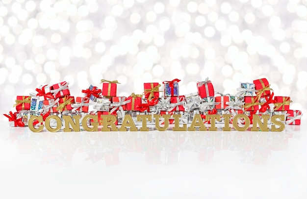 Congratulations golden text on the background of red and silver gifts on a bokeh background