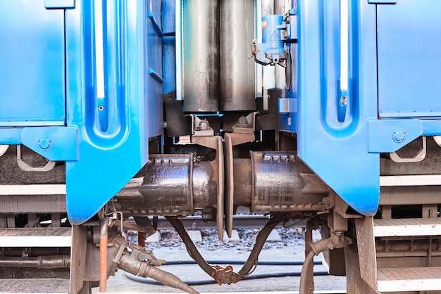 Connection between passenger cars train on railway, close up. Buffer automatic coupling