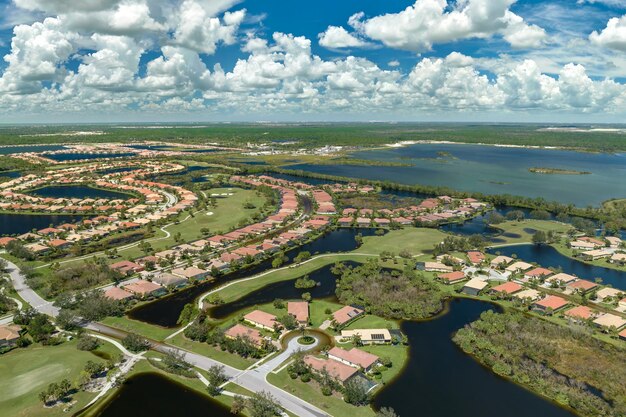 Consequences of natural disaster Heavy flood with high water surrounding residential houses after hurricane Ian rainfall in Florida residential area