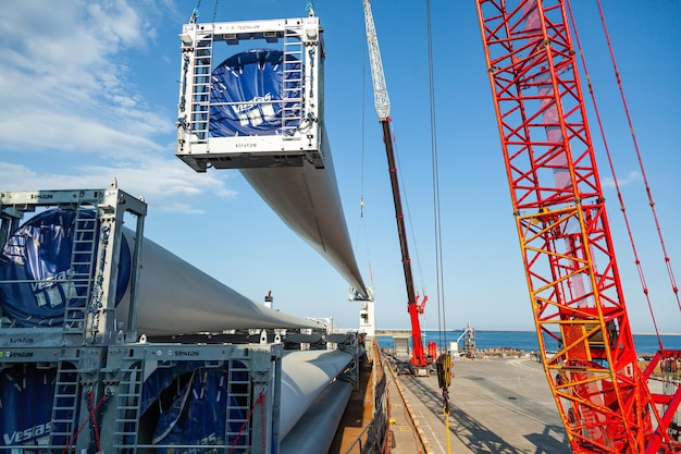 Constanta Romania 08032022 Loading in the seaport of Romania by the blades of Vestas windmills two cranes per cargo ship