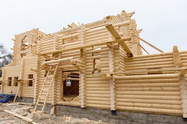 Construction of a Christian church made of wooden treated logs by hand without nails