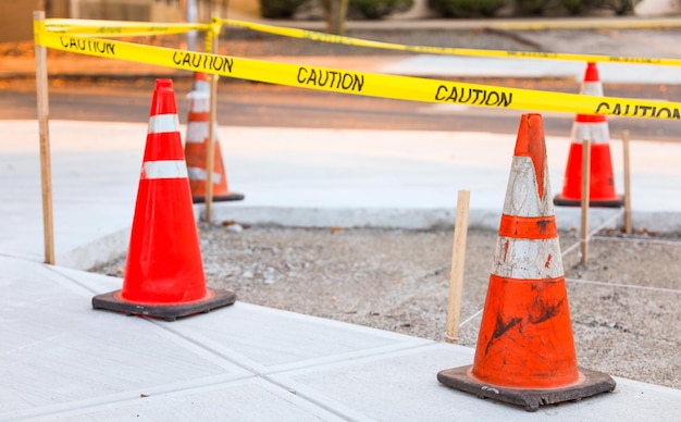 construction cone standing alone on a sunlit urban street symbolizing safety roadwork caution a