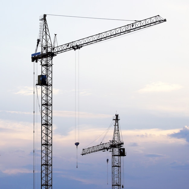 Construction crane on the background of the evening sky. industry manufacturing