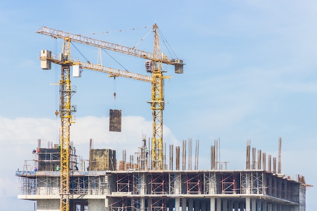 construction cranes over building site