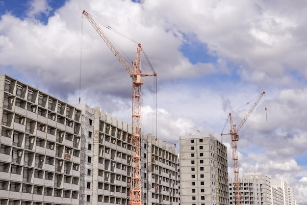 Construction cranes and multi-storey houses under construction