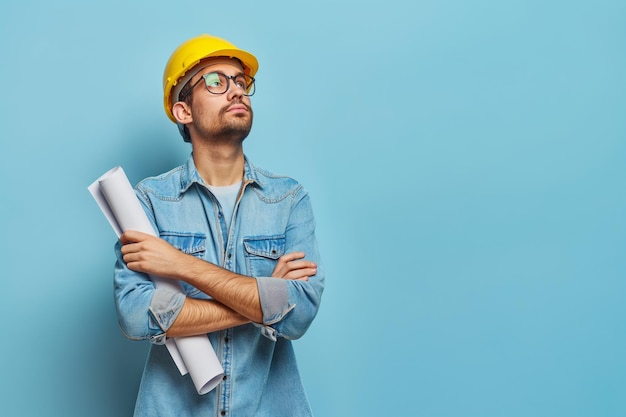 A construction engineer holding blueprint isolated on background