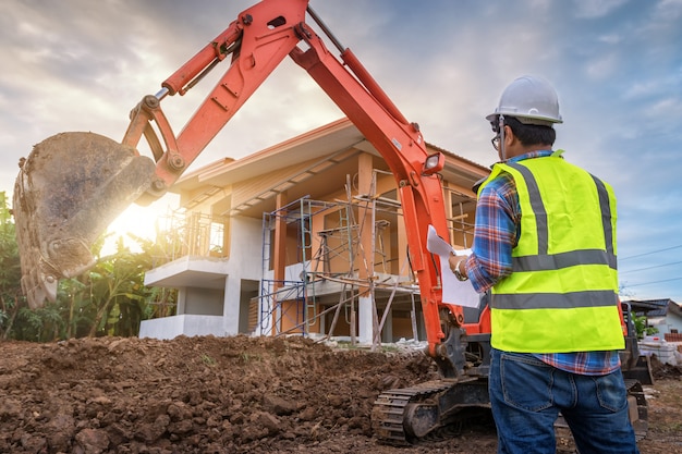 Construction engineer Stands in control of work in the construction site