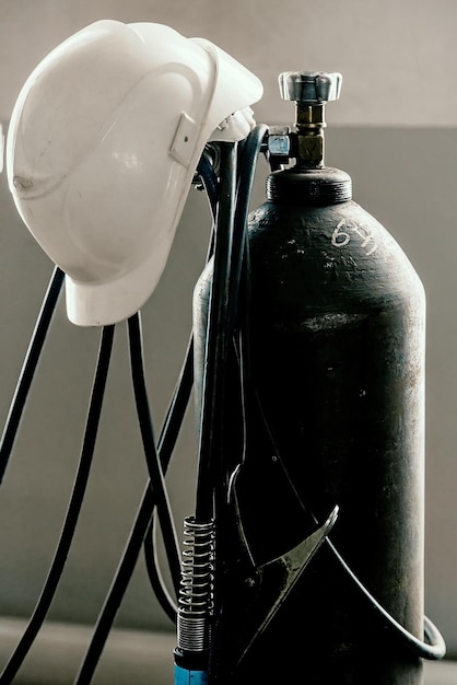 Construction helmet is worn on oxygen cylinder in welding shop Industry and construction