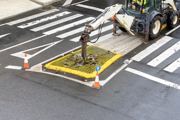 Construction Machine jackhammer working on a city road