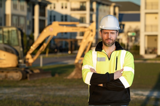 Construction man industry with excavator at industrial site Worker in helmet build with bulldozer Engineer work with builder contractor in hardhat Excavation foreman with tractor