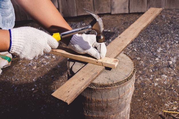 Construction man workers in blue shirt with Protective gloves working with hammer