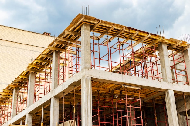 Construction of a new monolithic reinforced concrete house Formwork for pouring the next floor Working at height on a construction site