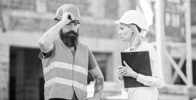 Construction project inspecting Construction inspection corrections and fines Safety inspector concept Discuss progress project Inspector and bearded brutal builder discuss construction progress