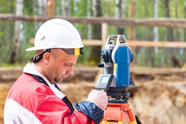 Construction of a residential area Geodetic stakeout Surveyor at a large construction site A man with a tachometer during work Makshader