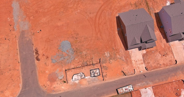 Construction site of unfinished subdivision with incomplete neighborhoods from an aerial view