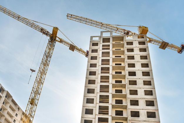 Construction site with buildings and industrial cranes