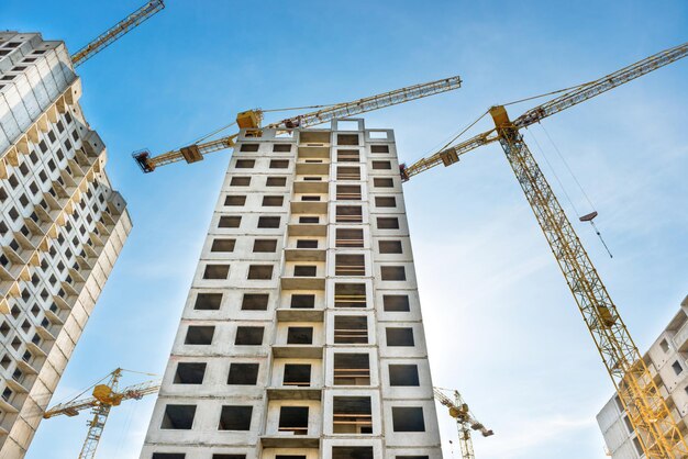 Construction site with buildings and industrial cranes