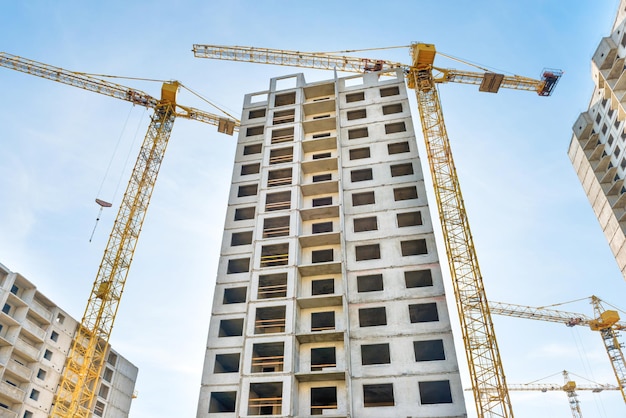 Construction site with buildings and industrial cranes