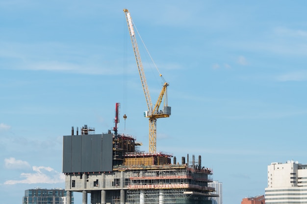 Construction site with cranes on the background of the day sky