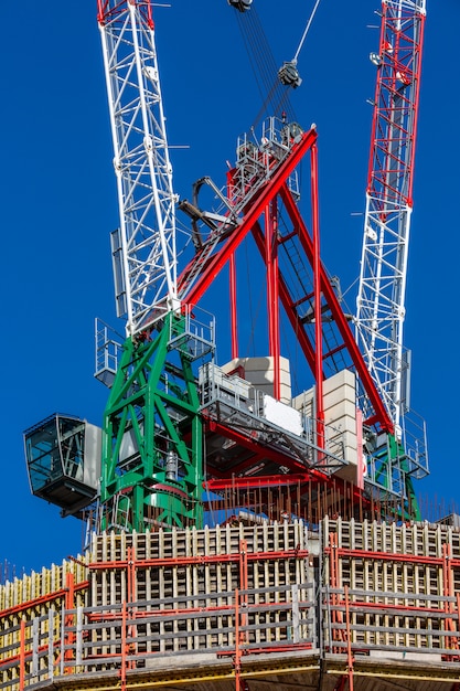 Construction site with cranes, blue sky on the background