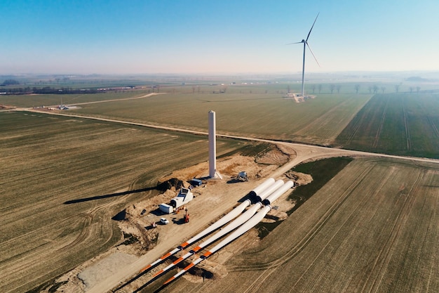 Construction site with windmill turbine parts on ground