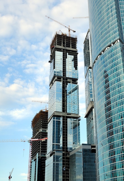 Construction of skyscrapers from glass, a steel and concrete of a complex of the business centre