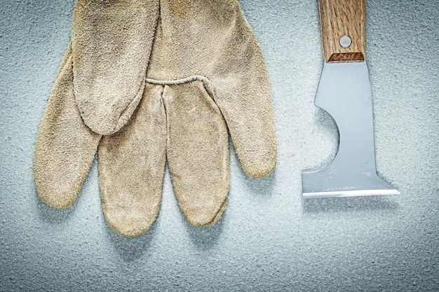 Construction spatula safety gloves on concrete surface building concept.