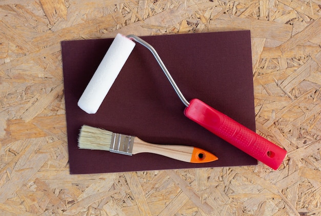 Photo construction tools - brushes, rollers, spatulas and sandpaper on a concrete background