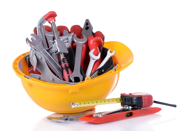 Construction tools in helmet isolated on white