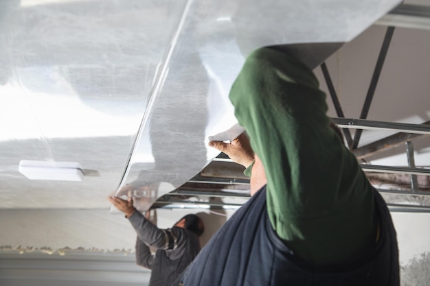 Construction worker assemble a suspended ceiling