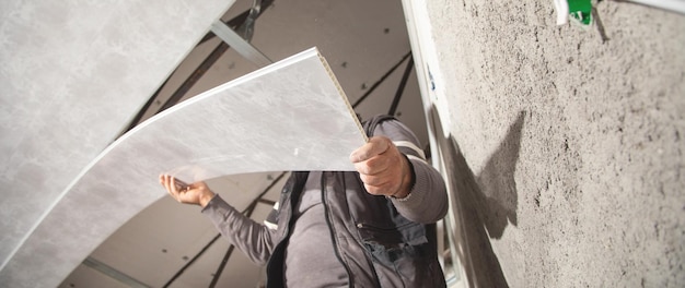 Construction worker assemble a suspended ceiling