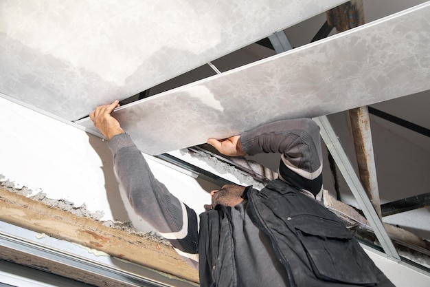 Construction worker assemble a suspended ceiling