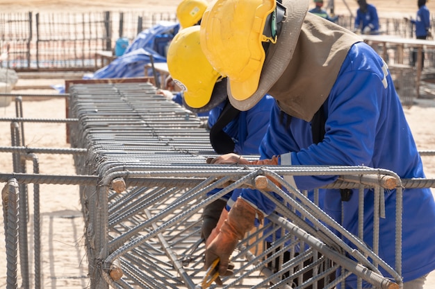 A construction worker fixing steel bar at construction site