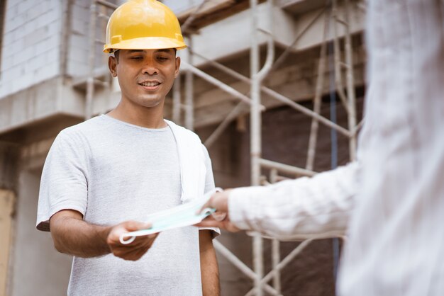 Construction worker given a mask while working on a site project