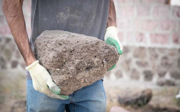 Construction worker holding a quartz stone.