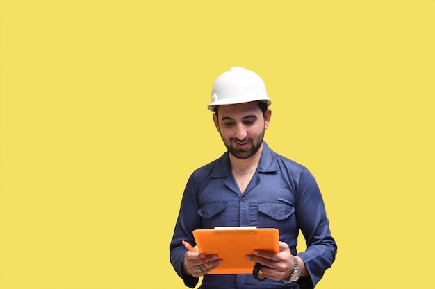 construction worker smiling holding clipboard and looking it indian pakistani model